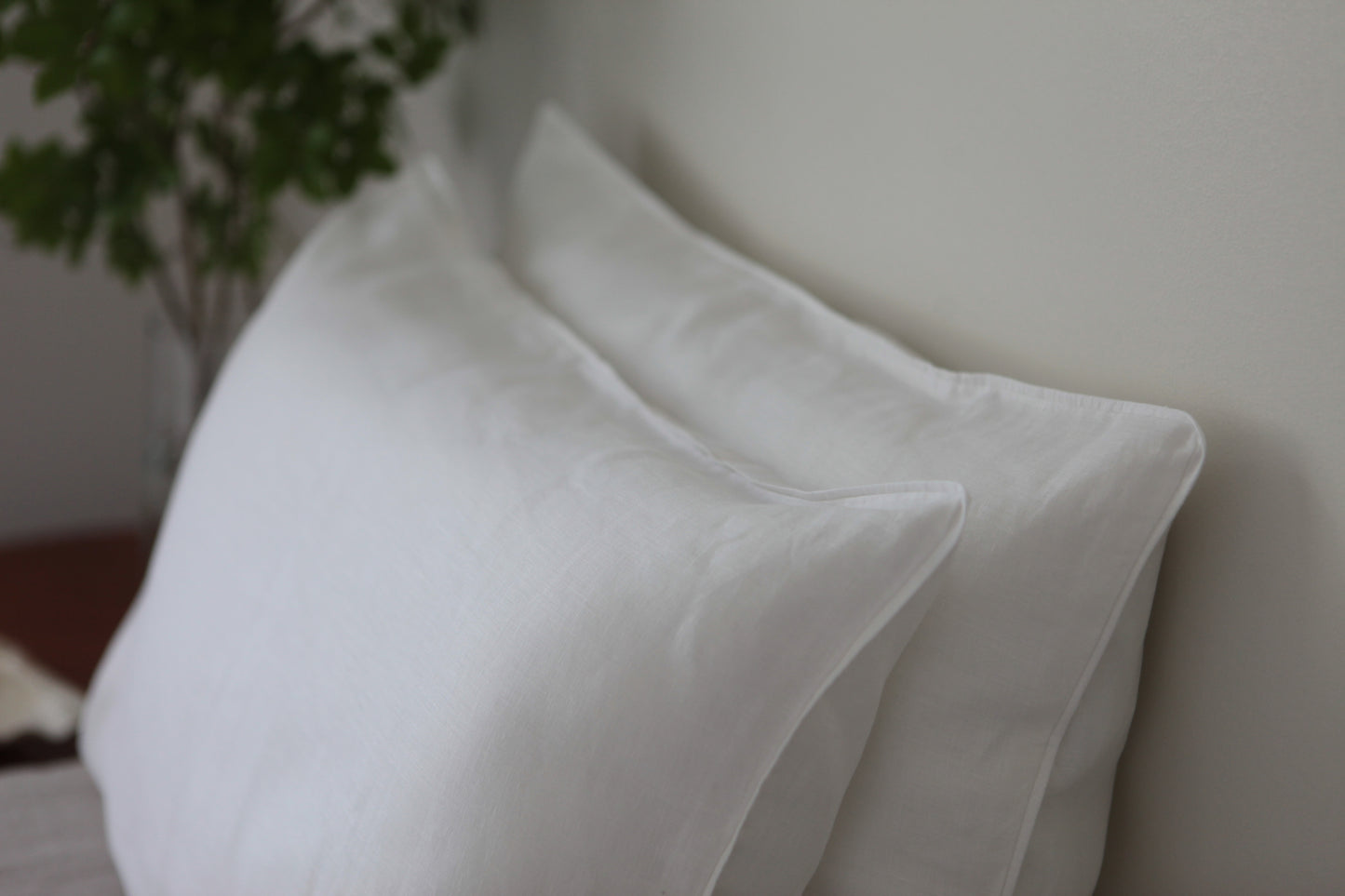 White linen pillow case with with linen piping. Side shot, two pillowcases stacked. 