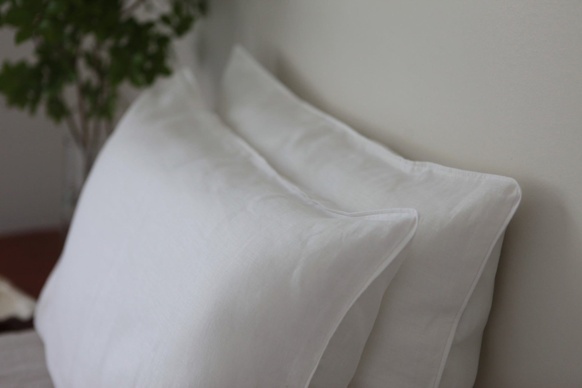 White linen pillow case with with linen piping. Side shot, two pillowcases stacked. 