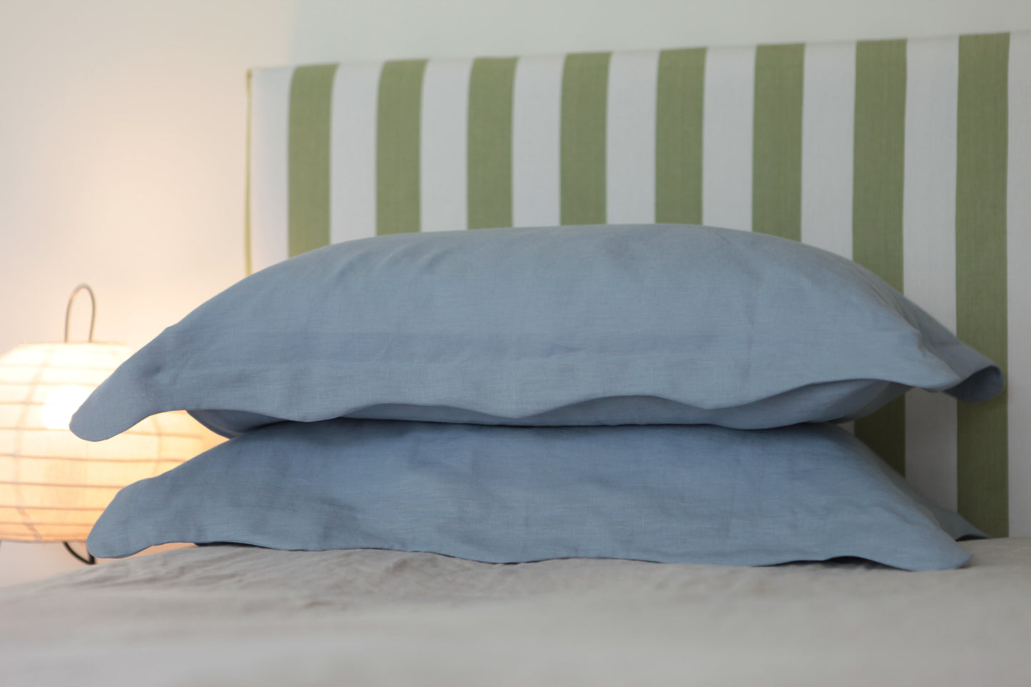 Sky blue linen pillowcases with organic wave edge border. Close up, front on photo. 