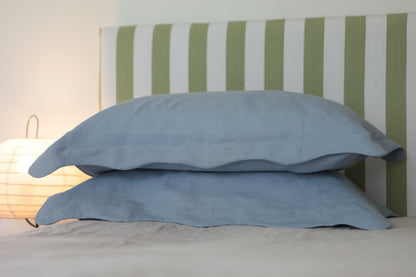 Sky blue linen pillowcases with organic wave edge border. Close up, front on photo. 