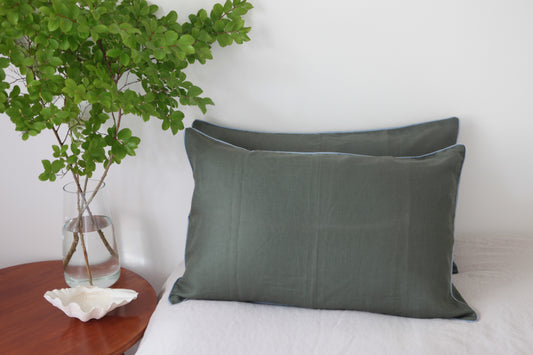 Khaki linen pillowcases with sky blue linen piping. Front on photo. 