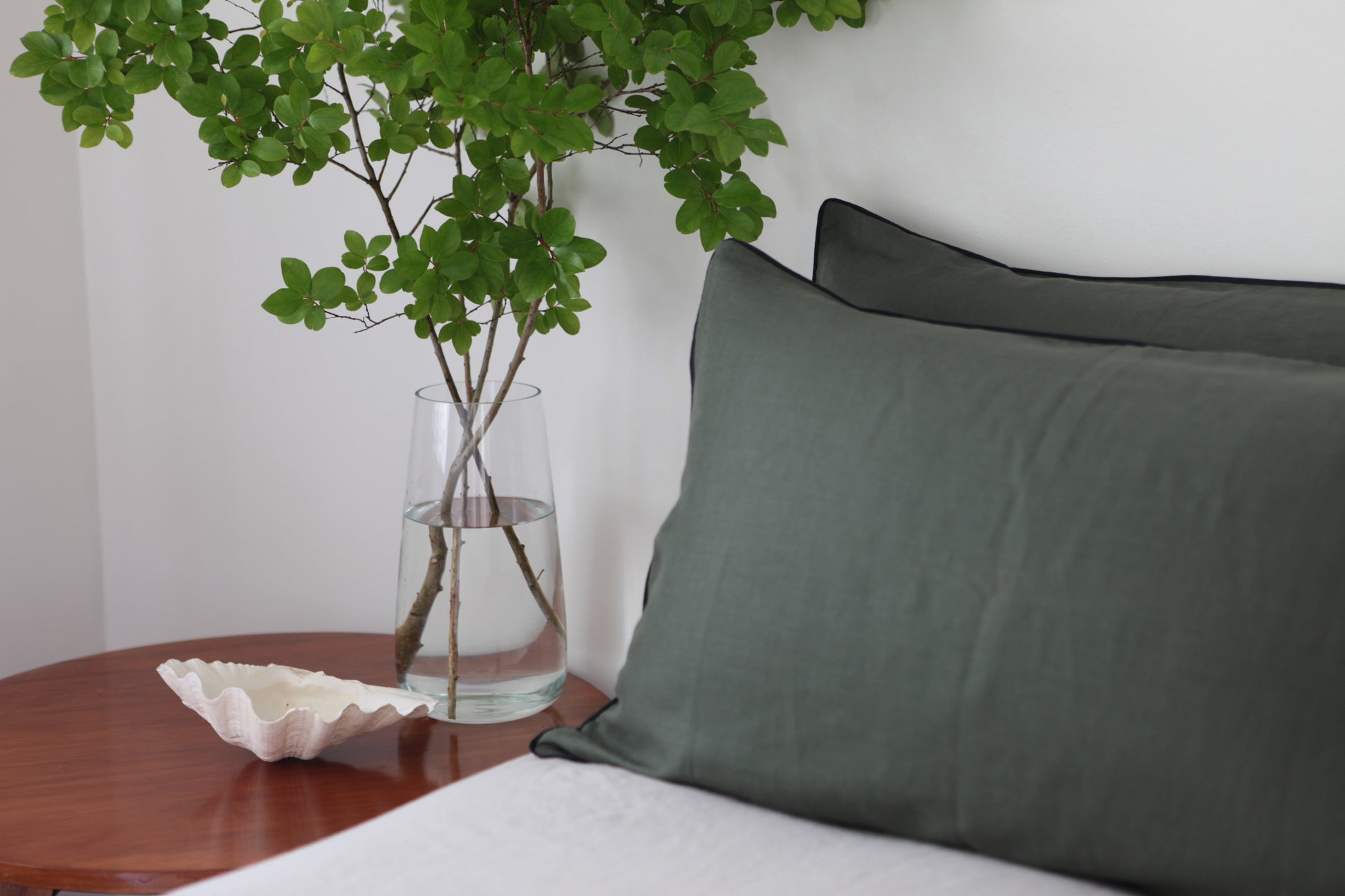 Khaki linen pillowcase with navy piping. Side studio shot. 
