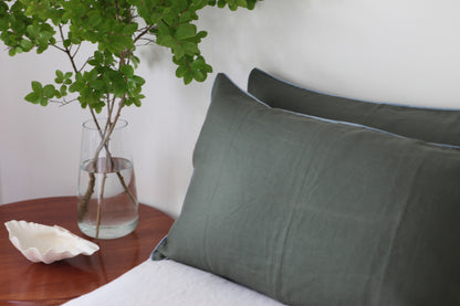 Khaki linen pillowcases with sky blue piping. Side photo. 