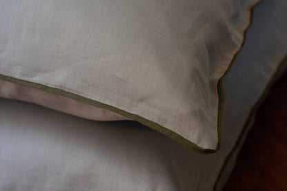 Close up image of khaki linen piped edge with sky blue linen body. 