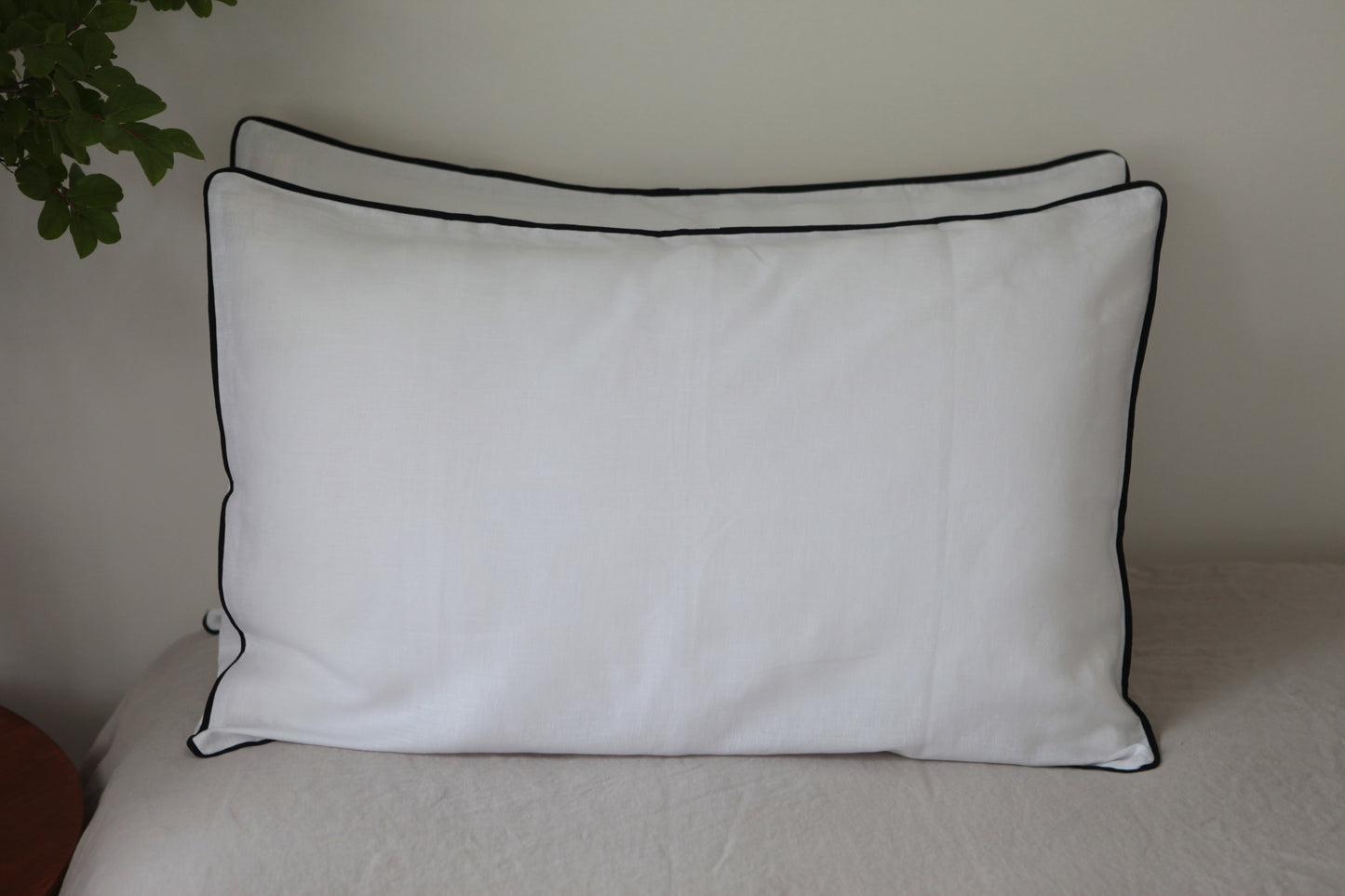 White linen pillowcases with navy linen piping. Front on photo. 