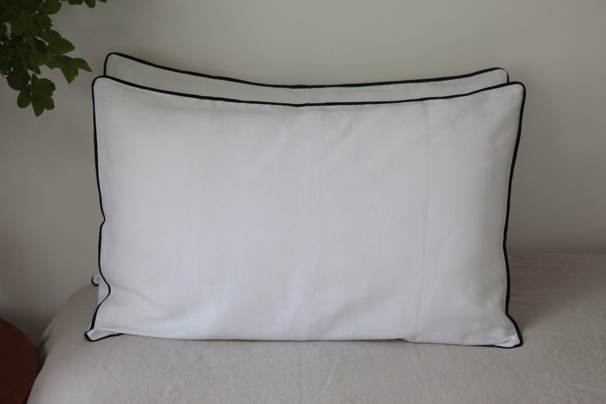 White linen pillowcases with navy linen piping. Front on photo. 