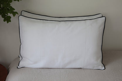 White linen pillowcases with navy linen piping. Front on photo. 
