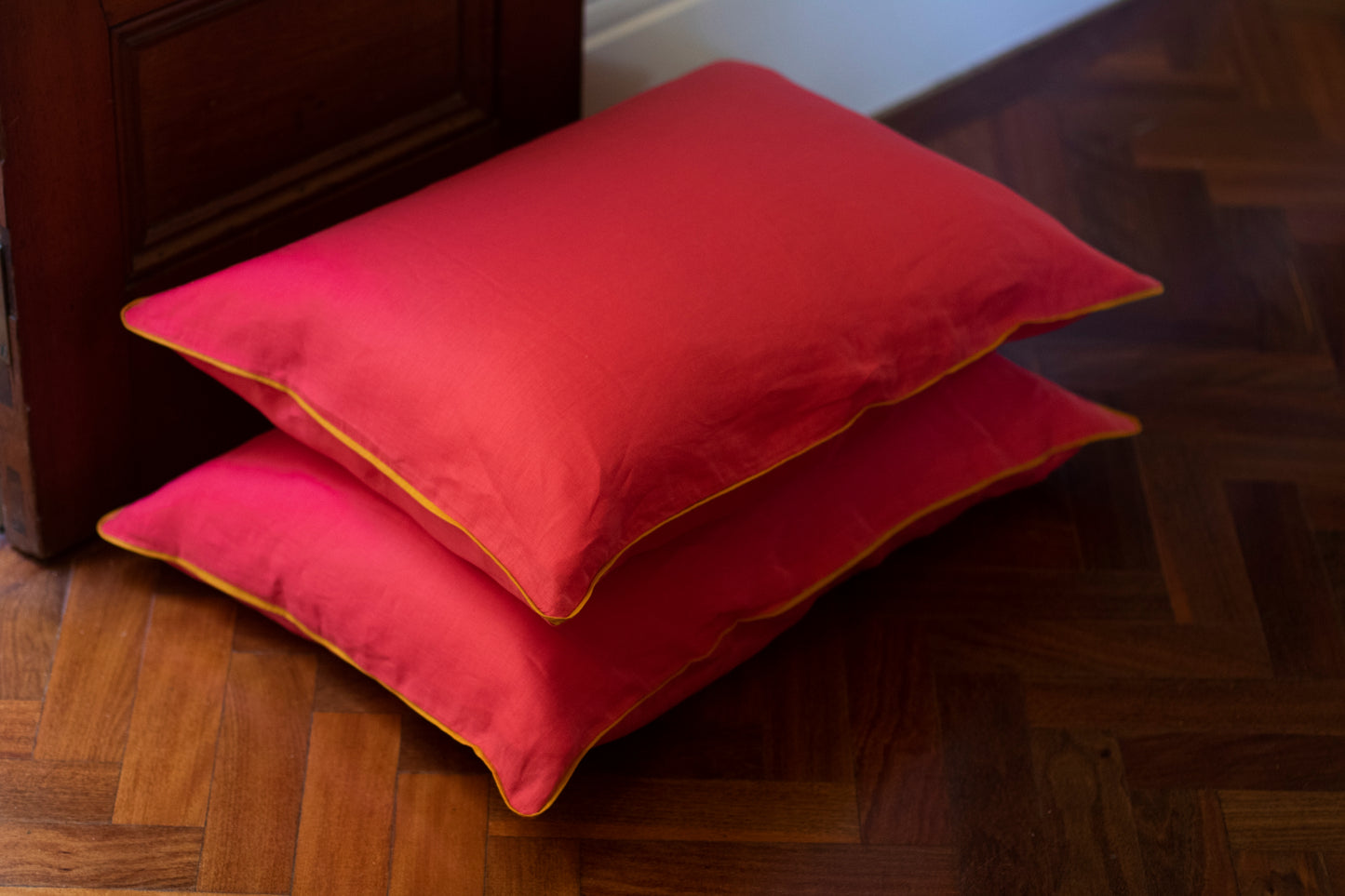 orange linen piping with magenta linen body. Stacked set 2 x pillows. 
