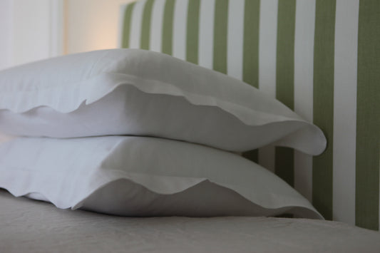 White linen pillowcases with organic wave edge border. Photo on corner angle. 