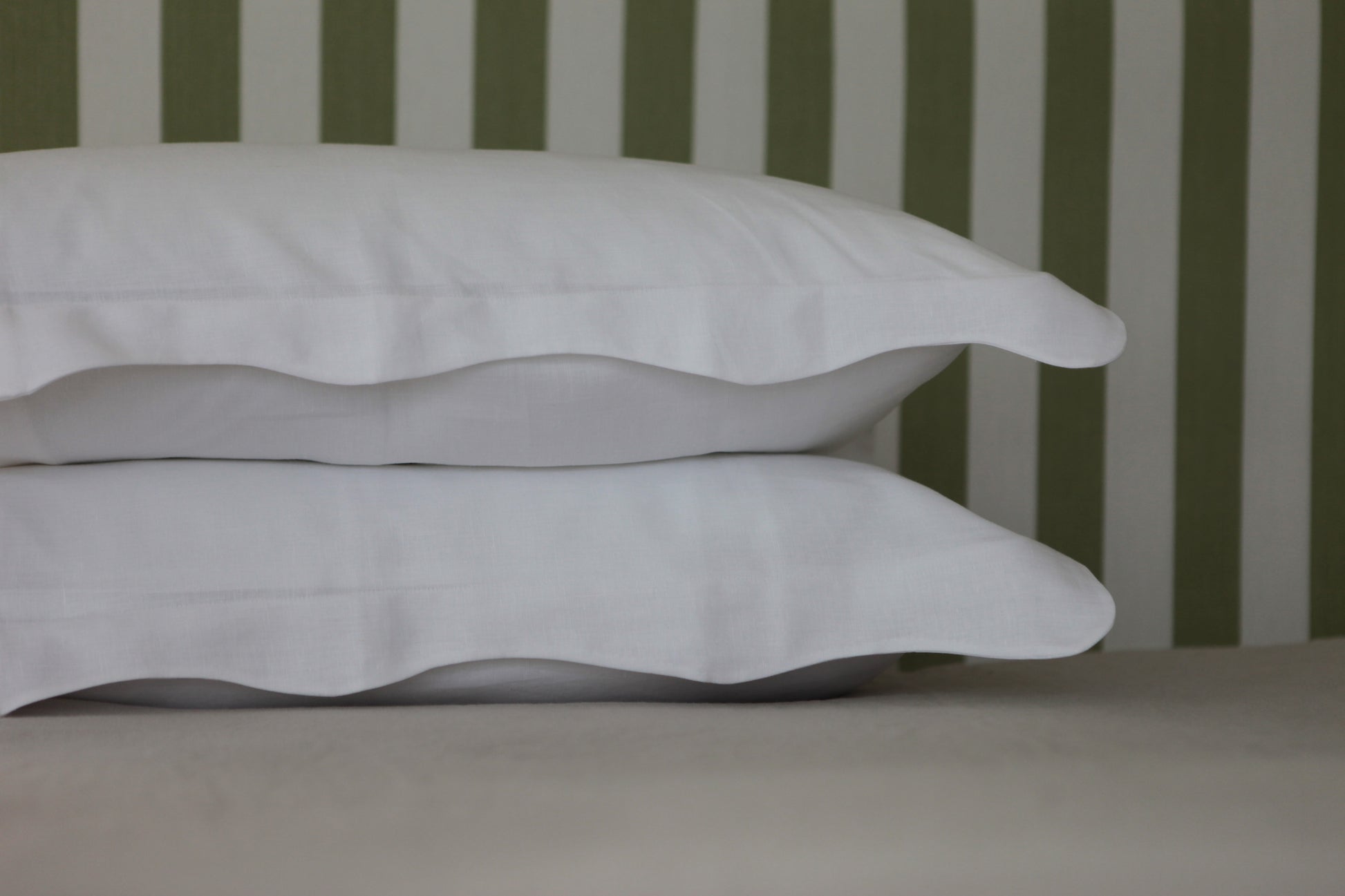 White linen pillowcases with organic wave shaped edge. Close up photo. 