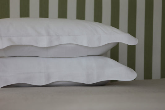 White linen pillowcases with organic wave shaped edge. Close up photo. 